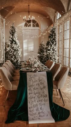 a table with a sign on it in the middle of a room filled with christmas trees