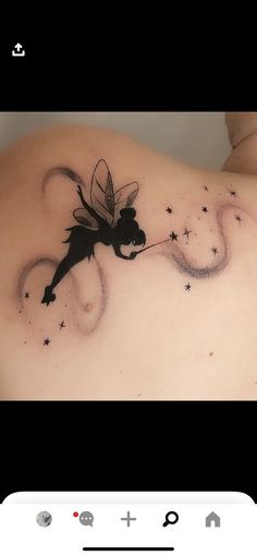 the back of a woman's shoulder with a fairy on it and stars in the sky