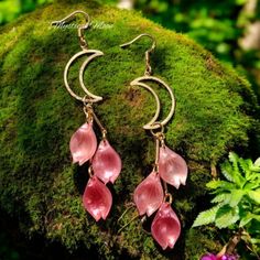 Handmade by me / Unique One of a kind piece  Nickel Free 925 Sterling Silver Copper Plated Hooks  Approximate length: 3.5" Elevate your style with these exquisite crescent moon shaped earrings adorned with captivating coral-hued leaves!  Crafted with meticulous attention to detail, the golden crescent moons gracefully suspend the vibrant coral accents, creating a harmonious blend of elegance and allure. Whether you're attending a formal event or seeking to add a touch of sophistication to your everyday ensemble, these earrings are sure to captivate and enchant. With their lightweight construction and secure hook closures, they offer both comfort and security.  Embrace the timeless beauty of these earrings and let them be the stunning centerpiece that elevates your overall look. Handmade Whimsical Moon Earrings, Mystical Dangle Earrings, Mystical Moon Shaped Earrings, Mystical Moon-shaped Pierced Earrings, Mystical Moon Charm Dangle Crystal Earrings, Witchy Earrings, Fairy Earrings, Coral Accents, Coral Color