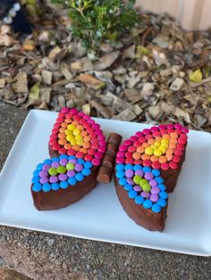 a heart shaped chocolate cake decorated with colorful candies