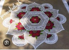 a white doily with red flowers on it