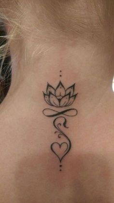 a woman's neck with a tattoo on the back of her neck and a heart