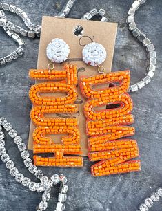 Be sure to check our shop announcements for any current sales or coupon codes!  All discount information will be posted there.  Light weight made with orange and white seed beads!  Length- Approx. 3.5" Back- Post back Felt back Nickel and lead compliant FINAL SALE- please check dimensions and details before purchasing, just to ensure these will work for you! Details~Policies~The fine print. :)  I want you to LOVE your purchase!!  If you have any questions, please just send me a message BEFORE yo Game Earrings, Touch Down, The Fine Print, Orange Earrings, Earrings Beaded, Fine Print, Loose Stones, Football Game, Work For You