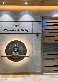 the entrance to an office building with a clock on it's wall and illuminated sign