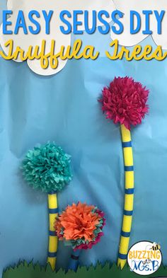 two paper flowers on top of each other with the words easy seuss diy umbrella trees