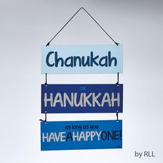 there are three signs hanging on the wall with one saying hanukkah as long as you have a happy one