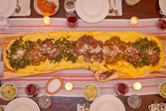 a table topped with lots of food and plates