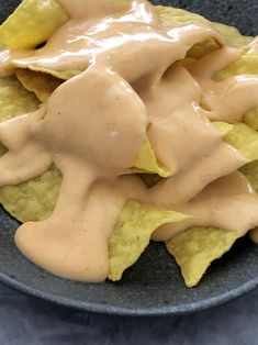 a plate filled with nachos covered in sauce