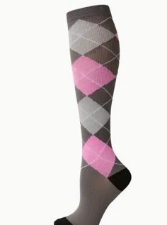 a pair of socks with pink and grey argyles on them, sitting in front of a white background