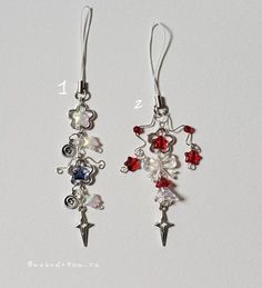 two pairs of earrings with red, white and blue beads hanging from hooks on a white surface