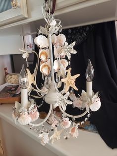 a chandelier with shells and seashells on it