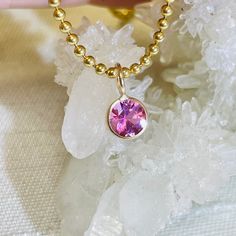 Featuring a natural and earthmined tourmaline with a gorgeous pink hue, and a round brilliant cut The fine gem is bezel wrapped solid 14K yellow gold with a round bail on top.  The bail has a 3mm inner diameter, round, but can be squeezed a little bit to make it more oval if necessary. The pendant is 9mm long x 6mm wide It can be worn alone or paired with another pendant. Pink Round Tourmaline Jewelry, Pink 14k Gold Jewelry With Bezel Setting, 14k Gold Pink Solitaire Jewelry, Gold Tourmaline Jewelry With Bezel Setting, Gold Jewelry With Round Cut Pink Sapphire, Pink Round Cut Tourmaline Jewelry, Pink Gemstone Accents Round Necklace, 14k Gold Pink Gemstone Jewelry, Pink 14k Gold Jewelry With Gemstone Accents