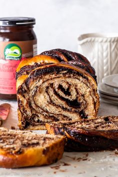 vegan chocolate bake with cinnamon swirl in the center and sliced up on a cutting board