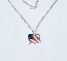 This listing is for one American Flag Pendant Necklace. Flag measures approximately 24 x 23mm and comes on a silver plated chain with lead/nickel free silver lobster clasp. Pendant comes in a colorful organza pouch. Please contact me for custom requests and/or larger quantities. Gift box may be purchased if sending as a gift.  May also include a note to recipient if desired (no extra charge). See matching earrings here:  https://www.etsy.com/listing/280145910/american-flag-earrings American Flag Jewelry For Independence Day Gift, Patriotic American Flag Jewelry Gift, Patriotic Silver Jewelry For Independence Day, Adjustable Patriotic Necklaces As A Gift, First American Flag, Flag Earrings, Organza Pouch, Usa Flag, Necklace Gift