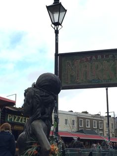 there is a statue in front of the market