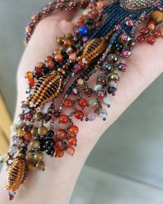 a woman's hand with many beads on it