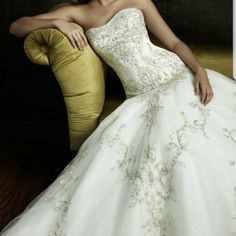 a woman in a white wedding dress sitting on a yellow chair and posing for the camera