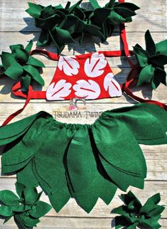 the green and red flower headbands are laying on top of wood planks