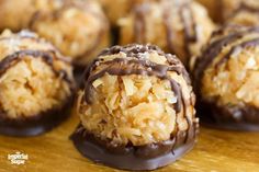 chocolate covered coconut balls on a wooden table