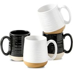 three black and white coffee mugs sitting next to each other