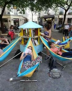 some people are laying in hammocks and reading books