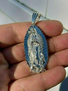 Gorgeous handmade Virgin Mary pendant
Will never turn green! SOLID 925 SILVER...Great investment!
1x2"Pendant weighs 9 grams!VERY DETAILED.Amazing handmade pieceYou can buy pendant alone or with choice of  2.5mm solid 925 silver chain.Chain is Made in Italy & comes in 18-30"If you look to buy only pendant it will fit most chains up to 5mm thick...would look really nice on a tennis chain too! Silver Our Lady Of Guadalupe Necklace, Silver Our Lady Of Guadalupe Pendant Jewelry, Spiritual Silver Necklace With Our Lady Of Guadalupe, Mary Guadalupe, Guadalupe Necklace, Virgin Mary Pendant, 10k Gold Chain, Red Stone Ring, Tennis Chain