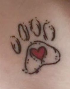 a dog paw with a heart tattoo on it