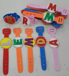 children's name clips and magnets are laid out on a table