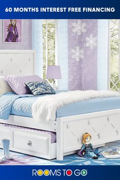 a white bed sitting in a bedroom next to a window with snowflakes on it