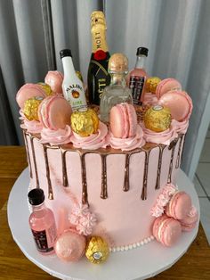 a cake decorated with pink icing and gold decorations