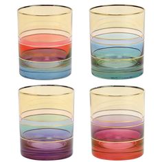 four different colored glasses sitting next to each other