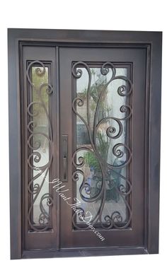 an iron door with glass panels and decorative designs on the front entrance to a home