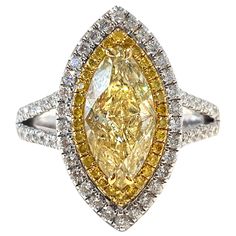 This Spectacular Yellow Color W-X 2.01 Carat Clarity SI2 GIA certified Marquise Diamond which is set in the center with 0.14 Carat of Round Brilliant cut Fancy Intense Yellow Diamonds on the perimeter with an additional 0.60 Carat of Round White Brilliant Diamonds on the Outer Halo flowing down the side of the shank giving this Double Halo Diamond Engagement Ring an exceptional and unique look in its 18 Karat White Gold setting. Ring size UK - N 1/2, US - 7 1/2, other sizes and Gem stones may be Gold Double Halo Engagement Ring, Marquise Engagement Ring Gold, Double Halo Diamond Engagement Ring, Double Halo Engagement Ring, Double Halo Engagement, Marquise Diamond Ring, Yellow Diamonds, Yellow Diamond Rings, High Jewellery