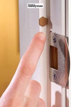 a person is pressing the button on a door handle to open it with their finger