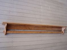 a wooden shelf hanging on the side of a building