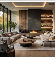 a living room with couches, tables and a fire place in the middle of it