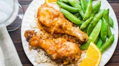 a plate with chicken, rice and green beans