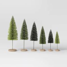 five small trees are lined up in the shape of different shapes and sizes, all on top of each other