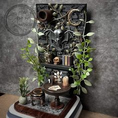 a shelf with plants and other items on it in front of a wall mounted sculpture