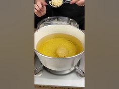 a person is spooning some soup into a bowl