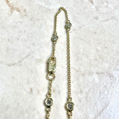 Beautiful 14 karat yellow gold Diamond By The Yard bracelet / station bracelet. It is set with 5 fine round diamonds weighing 0.30 CTTW.The stones are G-H in color and SI1 in clarity. The bracelet is 7 inches long. It is equipped with a lobster clasp. Stamped 14K DSD N & 585. It weighs 1.09 gram. Each bezel is 3.45 mm in width. Chain is 1.15 mm wide. Birthstone: April. Condition: Excellent. Brand New. - 14-day return policy, no questions asked.- Free insured shipping in the US.- International sh Yellow Gold Cubic Zirconia Bracelet With Bezel Setting, Yellow Gold Bracelet With Bezel Setting Cubic Zirconia, Timeless Gold Bracelet With Single Diamond, Yellow Gold Diamond Bracelet With Bezel Setting, Timeless Gold Diamond Bracelet With Bezel Setting, Gold Diamond Bracelet With Bezel Setting In 14k Gold, Luxury Gold Bracelet With Bezel Setting, Classic Gold Bracelet With Bezel Setting, Gold Bracelet With Bezel Setting For Formal Events