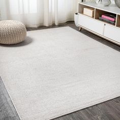 a large white rug in a living room