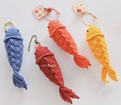 three crocheted fish keychains are shown