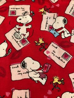 peanuts on red fabric with writing and pictures all over the print, including an image of snoop