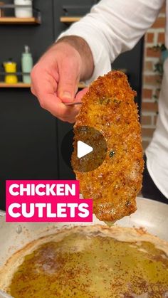 the chicken cutlets are being held up in front of an open frying pan