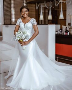 a woman in a wedding dress holding a bouquet