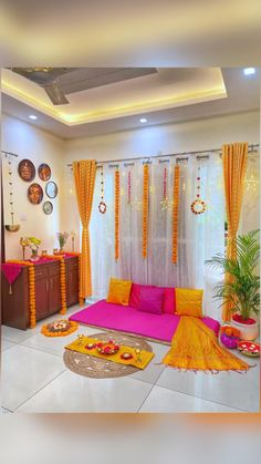 a living room filled with lots of furniture next to a window covered in yellow drapes