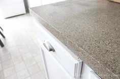 a counter top in a kitchen with white cabinets