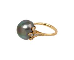 Elegant and distinctive, this Shinkai pearl ring exudes a feminine sophistication. The domed gray South Sea pearl has a stunning natural nacre. It is set in 18K yellow gold and diamond petals at the center on the slightly tapered matte 18K yellow gold band. It exudes a stunning, statement-making presence. south sea pearl : 14mm diameterdiamonds : vary : just under 1mm diameter to 2mm diameter each : .29cttw18K yellow gold band width : 1.5mm to 2.5mmsize available : 6.5please contact us for sizin Gold Tahitian Pearl Ring Fine Jewelry, Wedding Tahitian Pearl Ring In Yellow Gold, Wedding Yellow Gold Tahitian Pearl Ring, Luxury Tahitian Pearl Ring In Yellow Gold, Luxury Yellow Gold Tahitian Pearl Ring, Gold Tahitian Pearl Rings For Wedding, Elegant Yellow Gold Tahitian Pearl Rings, Formal Yellow Gold Tahitian Pearl Ring, Luxury Tahitian Pearl Wedding Rings