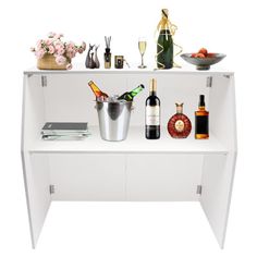 a white shelf with bottles and glasses on it